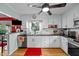 Bright kitchen features white cabinets, stainless steel appliances, and open layout for easy meal preparation and entertaining at 6404 Dixon Dr, Raleigh, NC 27609