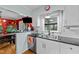 Bright kitchen with stainless steel appliances, white cabinetry, black countertops, and eat-in bar area at 6404 Dixon Dr, Raleigh, NC 27609