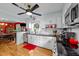 Open-concept kitchen with stainless steel appliances, white cabinets, contrasting countertops, and view to dining room at 6404 Dixon Dr, Raleigh, NC 27609