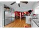 Spacious kitchen adjacent to dining room, showcasing stainless steel refrigerator and modern appliances for culinary enthusiasts at 6404 Dixon Dr, Raleigh, NC 27609