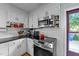 Efficient kitchen design with stainless steel oven, black countertops, and ample storage space, ideal for cooking at 6404 Dixon Dr, Raleigh, NC 27609