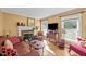 Comfortable living room with fireplace, large windows, and hardwood floors at 6404 Dixon Dr, Raleigh, NC 27609