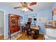Bright home office with light blue walls, wood floors, ceiling fan, and wood desk at 6404 Dixon Dr, Raleigh, NC 27609