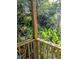Wooden porch with greenery and surrounding foliage offering a tranquil outdoor space at 6404 Dixon Dr, Raleigh, NC 27609