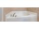 Bathroom features a soaking tub with tile surround and chrome fixtures at 705 Keystone Park Dr # 51, Morrisville, NC 27560
