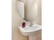 Bathroom features a modern white sink with pedestal base, framed round mirror, and soap dispenser at 705 Keystone Park Dr # 51, Morrisville, NC 27560