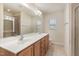 Bright bathroom features a dual sink vanity with wood cabinets, and a large mirror at 705 Keystone Park Dr # 51, Morrisville, NC 27560
