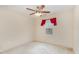 Bedroom with neutral walls, plush carpet, ceiling fan, and a window with red curtains at 705 Keystone Park Dr # 51, Morrisville, NC 27560