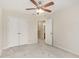 Bedroom features a ceiling fan, neutral walls, plush carpeting, and a closet with double doors at 705 Keystone Park Dr # 51, Morrisville, NC 27560