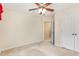 Beige bedroom featuring a ceiling fan, carpet floors, and a door leading to another room at 705 Keystone Park Dr # 51, Morrisville, NC 27560