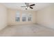 Bright bedroom features neutral walls, plush carpeting, a ceiling fan, and three large windows with blinds at 705 Keystone Park Dr # 51, Morrisville, NC 27560