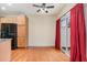 Bright dining area with hardwood floors, sliding glass door to the backyard, and red curtains at 705 Keystone Park Dr # 51, Morrisville, NC 27560