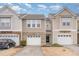 Charming townhome featuring a one-car garage, brick accents, and neutral siding in a well-maintained community at 705 Keystone Park Dr # 51, Morrisville, NC 27560