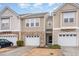 Charming townhome featuring a one-car garage, brick accents, and neutral siding in a well-maintained community at 705 Keystone Park Dr # 51, Morrisville, NC 27560
