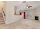 Cozy living room featuring neutral carpeting, fireplace, ceiling fan, and open access to the kitchen at 705 Keystone Park Dr # 51, Morrisville, NC 27560
