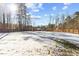 Expansive snowy backyard enclosed by a wooden fence, perfect for outdoor activities at 7103 Big Horn Dr, Hillsborough, NC 27278