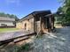 Brick home featuring a wood deck, partial privacy fence, and gravel area at 7103 Big Horn Dr, Hillsborough, NC 27278