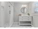 A clean and well-lit bathroom with a walk-in shower and elegant vanity at 7103 Big Horn Dr, Hillsborough, NC 27278