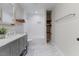Modern bathroom featuring gray vanity, marble floors, recessed lights, tub and shower combination at 7103 Big Horn Dr, Hillsborough, NC 27278