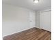 Bedroom with wood-look flooring and double door closet at 7103 Big Horn Dr, Hillsborough, NC 27278