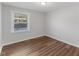 Bright bedroom with a window and wood-look flooring at 7103 Big Horn Dr, Hillsborough, NC 27278