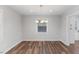 Bright dining room featuring modern light fixture and hardwood flooring at 7103 Big Horn Dr, Hillsborough, NC 27278