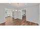 Open dining room with hardwood floors leads to a kitchen and living room at 7103 Big Horn Dr, Hillsborough, NC 27278