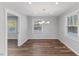 Dining room boasts hardwood floors, natural light from windows, and neutral paint at 7103 Big Horn Dr, Hillsborough, NC 27278