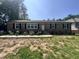 Charming single-story brick home with well-maintained landscaping and symmetrical design at 7103 Big Horn Dr, Hillsborough, NC 27278