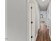 Hallway with wood-look flooring and white trim at 7103 Big Horn Dr, Hillsborough, NC 27278
