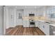 Bright kitchen featuring stainless steel appliances and white cabinets at 7103 Big Horn Dr, Hillsborough, NC 27278