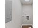 A utility room with connections for a washing machine and dryer, circuit breaker, and wood-look flooring at 7103 Big Horn Dr, Hillsborough, NC 27278