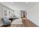 Bright living room featuring wood floors, recessed lighting, and natural light from a large window at 7103 Big Horn Dr, Hillsborough, NC 27278