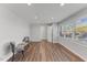 Bright living room featuring two chairs, wood-look flooring, and natural light at 7103 Big Horn Dr, Hillsborough, NC 27278