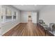 Bright living room with natural light, wood-look floors, recessed lighting, and stylish furniture at 7103 Big Horn Dr, Hillsborough, NC 27278