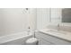Cozy bathroom with white subway tile in shower, vanity with white cabinets and quartz countertop at 7112 Camp Side Ct, Raleigh, NC 27613