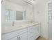 Spacious bathroom with double sinks, white cabinets, quartz countertops, and large mirror at 7112 Camp Side Ct, Raleigh, NC 27613