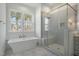 Modern bathroom featuring a soaking tub, a glass shower and natural light from the windows at 7112 Camp Side Ct, Raleigh, NC 27613