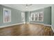 Spacious bedroom with hardwood floors, light green walls, large windows, and ceiling fan at 7112 Camp Side Ct, Raleigh, NC 27613