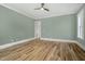 Bright bedroom with hardwood floors, neutral walls, window, and modern ceiling fan at 7112 Camp Side Ct, Raleigh, NC 27613