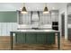 A gourmet kitchen boasts gray cabinets, a green island, and designer pendant lights at 7112 Camp Side Ct, Raleigh, NC 27613