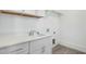 Functional laundry room with a sink, custom cabinets, and ample counter space at 7112 Camp Side Ct, Raleigh, NC 27613