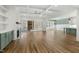 Open-concept living room featuring hardwood floors, built-in cabinets, a fireplace, and coffered ceilings at 7112 Camp Side Ct, Raleigh, NC 27613