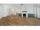 Open-concept living room featuring hardwood floors, fireplace and built-in shelving at 7112 Camp Side Ct, Raleigh, NC 27613