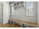 Bright mudroom with built-in shelving, bench, and natural light from the windows at 7112 Camp Side Ct, Raleigh, NC 27613