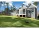View of screened in back porch and large lawn of backyard of home at 7112 Camp Side Ct, Raleigh, NC 27613