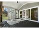 The screened in porch with stone fireplace has sliding doors to the home's interior at 7112 Camp Side Ct, Raleigh, NC 27613