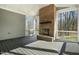 Cozy screened porch featuring a brick fireplace and open views of the surrounding trees at 7112 Camp Side Ct, Raleigh, NC 27613