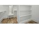 Custom walk-in closet with shelving, hanging rods, and a vanity area at 7112 Camp Side Ct, Raleigh, NC 27613