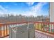 Outdoor deck with seating and a view of lush trees under a bright sky at 714 Cupola Dr, Raleigh, NC 27603